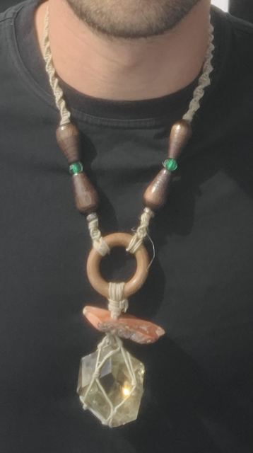 The finished crystal and wooden ring necklace being worn