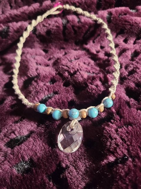 Twisted hemp necklace with turquoise and wood beads and a faceted clear pendant