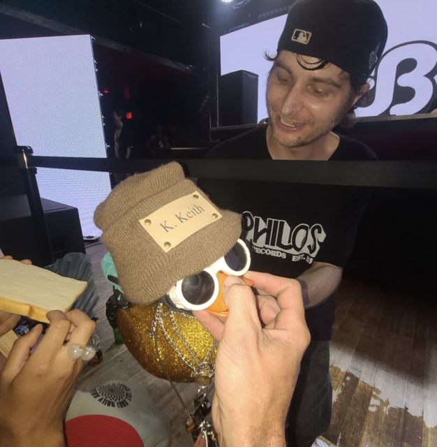 Producer Daily Bread signing the duck at a show